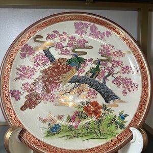 Vintage peacock plate with cherry blossoms.